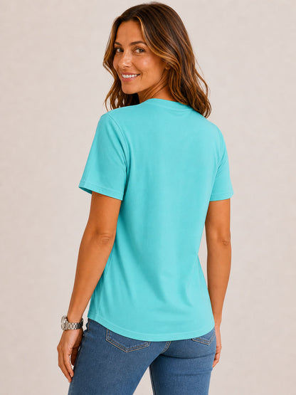 Woman wearing a LoomBasics turquoise crew neck 100% cotton tee and blue jeans.