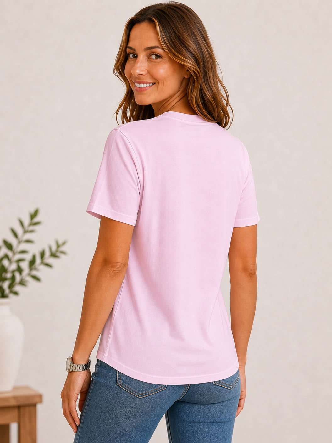 Woman wearing a pink 100% cotton crew neck tee and blue jeans from LoomBasics