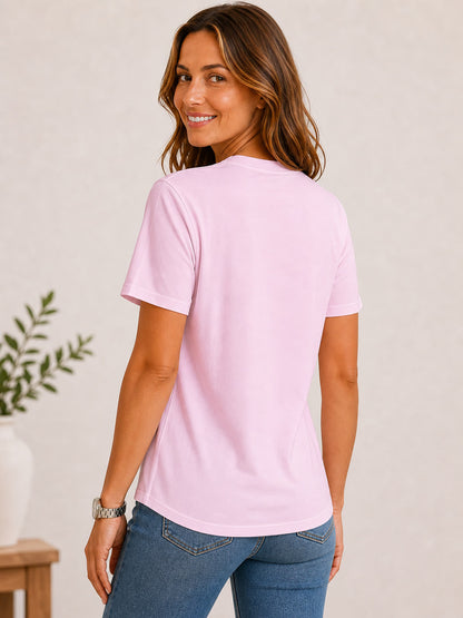 Woman wearing a pink 100% cotton crew neck tee and blue jeans from LoomBasics