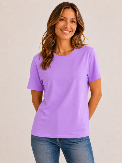 Woman wearing a LoomBasics purple 100% cotton crew neck top and blue jeans.