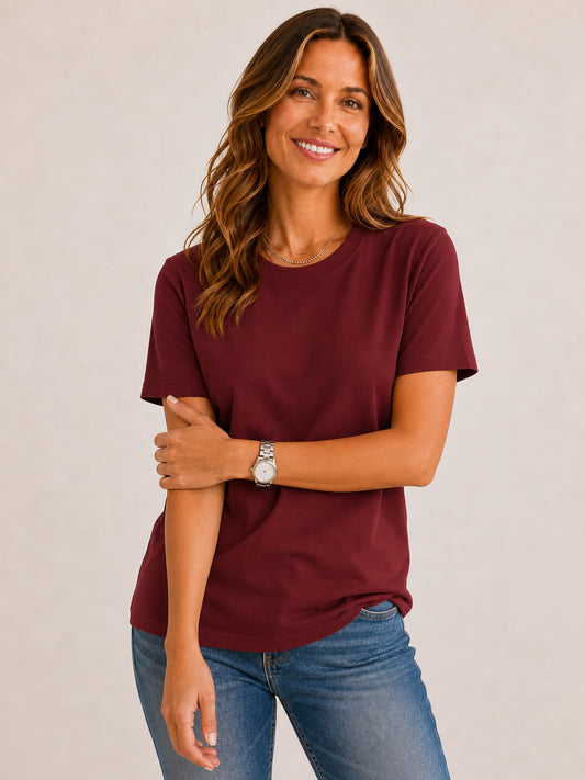 Woman wearing a LoomBasics burgundy 100% cotton crew neck top and blue jeans