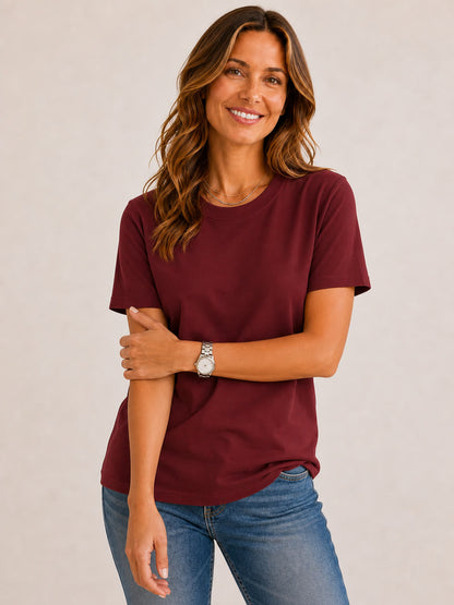Woman wearing a LoomBasics burgundy 100% cotton crew neck top and blue jeans