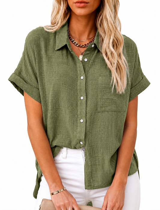 Woman wearing a LoomBasics olive green short sleeve button-up 100% cotton shirt and white pants.
