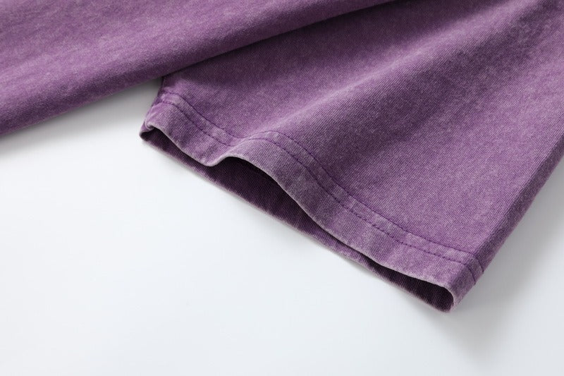 Close-up of the short sleeve hem on a purple 100% cotton crew neck tshirt by LoomBasics