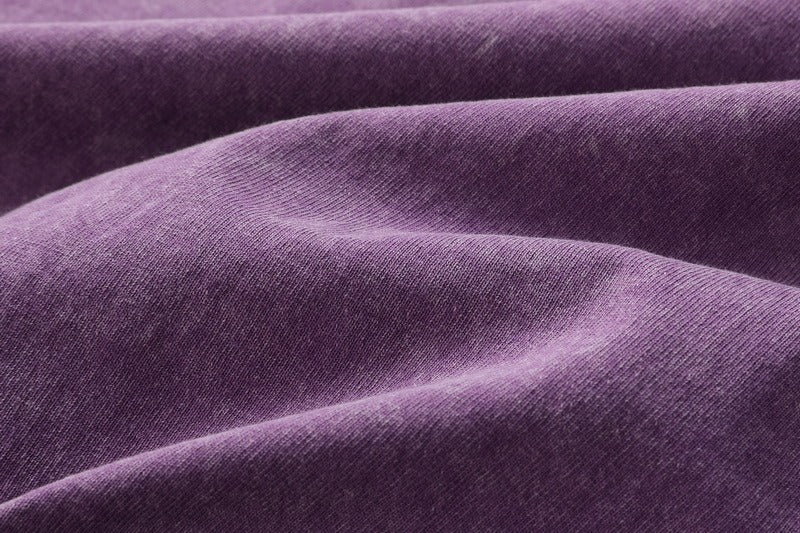 Close-up texture of purple 100% cotton fabric for a LoomBasics crew neck t-shirt.