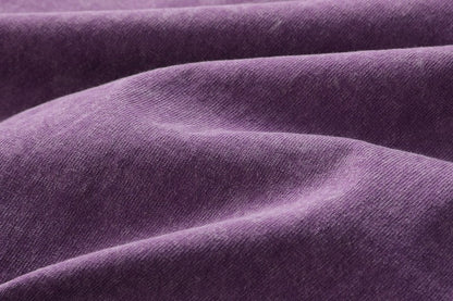 Close-up texture of purple 100% cotton fabric for a LoomBasics crew neck t-shirt.
