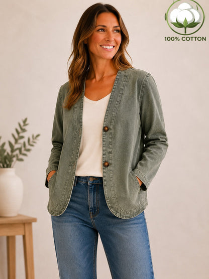 Woman wearing a LoomBasics vintage sage green 100% cotton button-up shirt and blue jeans.