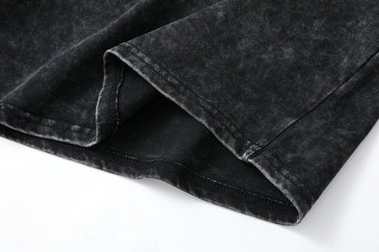 Close-up of the stitched hem of a LoomBasics 100% cotton short sleeve tee in washed black.