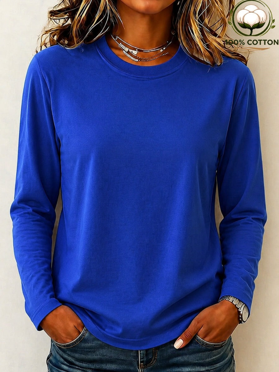 Woman wearing a LoomBasics royal blue 100% cotton crew neck long sleeve tee and denim jeans.