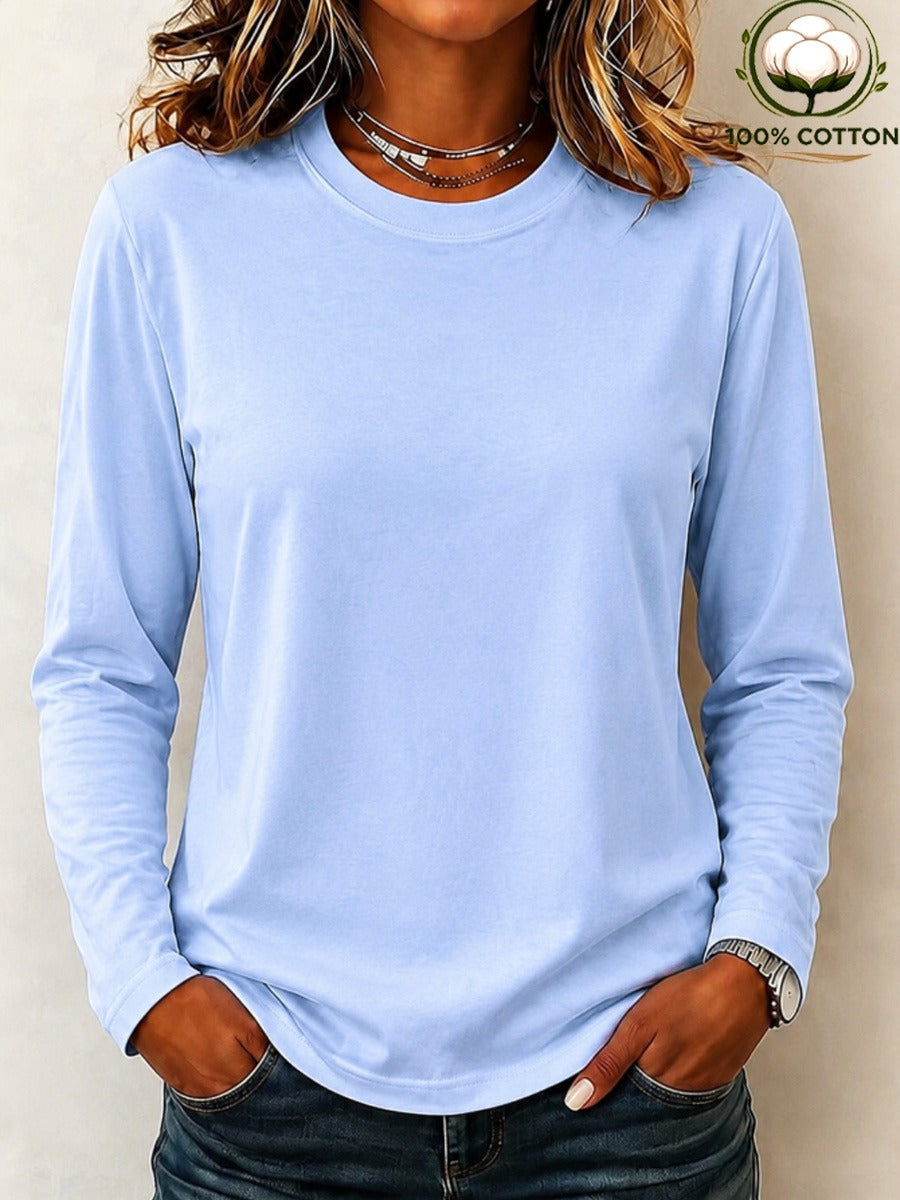 Woman wearing a LoomBasics light blue 100% cotton crew neck long sleeve tee and blue jeans.