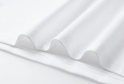 Close-up of the white cotton blend fabric of a LoomBasics mini T shirt dress.