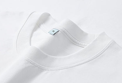 Close-up of the white cotton crew neck tee by LoomBasics featuring an XL size label.