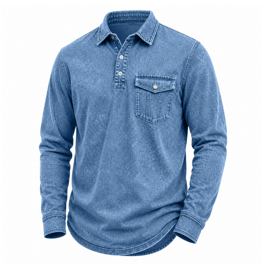 A men's long-sleeve button-up shirt in a washed blue denim-like fabric, featuring a pointed collar, a three-button placket, and a single chest pocket with a button closure, shown on a plain white background.