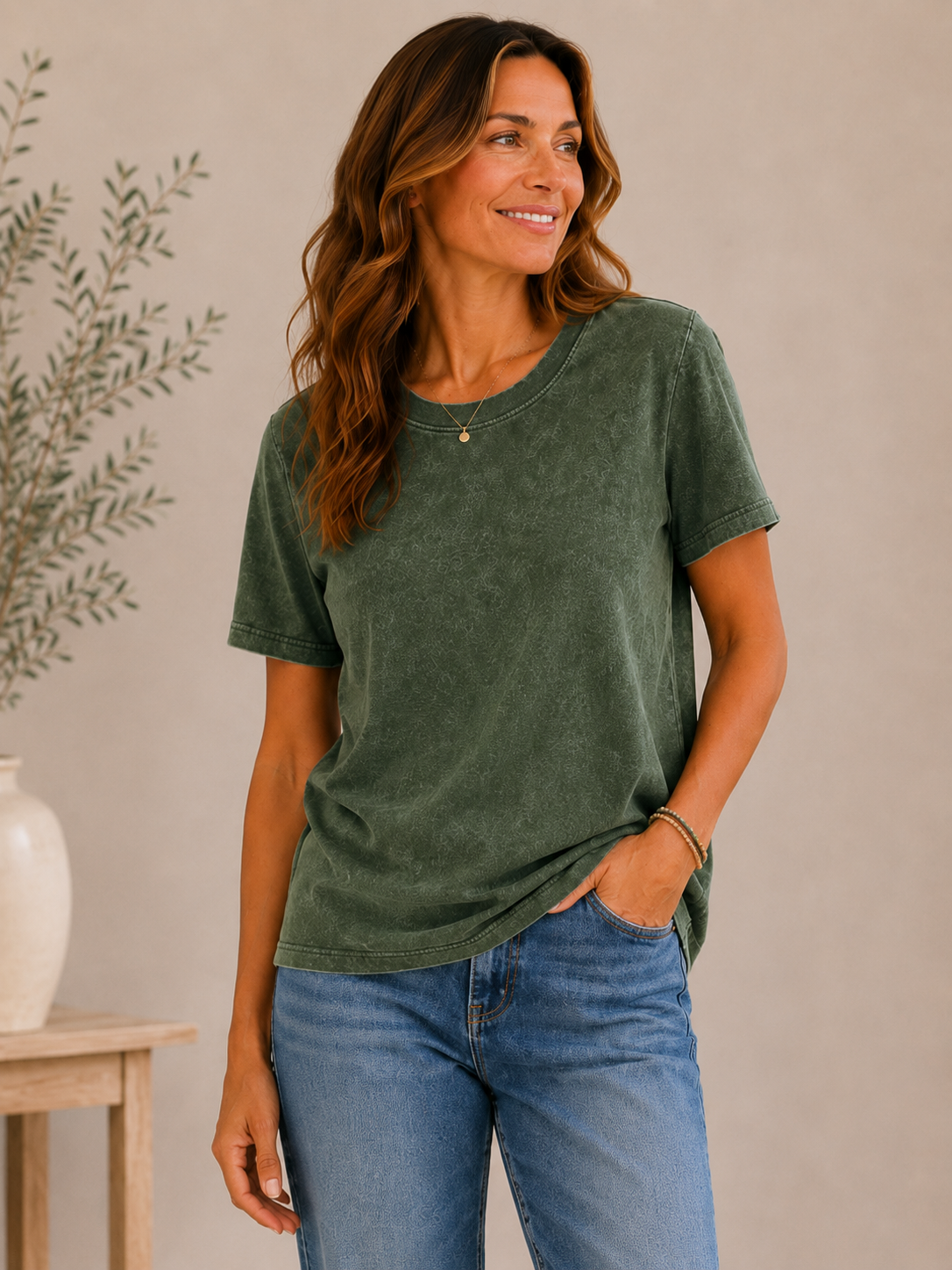 Woman wearing a LoomBasics olive green crew neck 100% cotton tee and blue jeans.