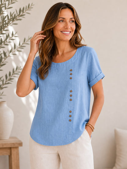 Woman wearing a LoomBasics soft blue 100% cotton button-down short sleeve blouse.