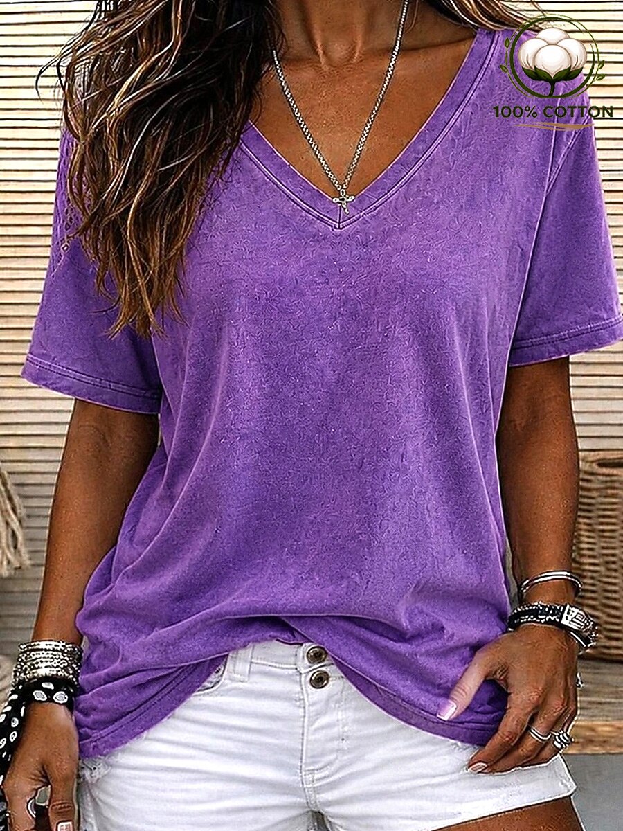 Woman wearing a LoomBasics purple 100% cotton V-neck tee with white denim shorts.