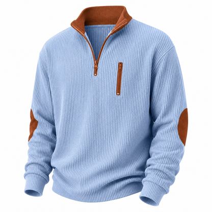 A men's quarter-zip pullover sweater in light blue ribbed knit, featuring brown contrast trim on the collar, zipper pulls, elbow patches, and inner lining, shown on a plain white background.