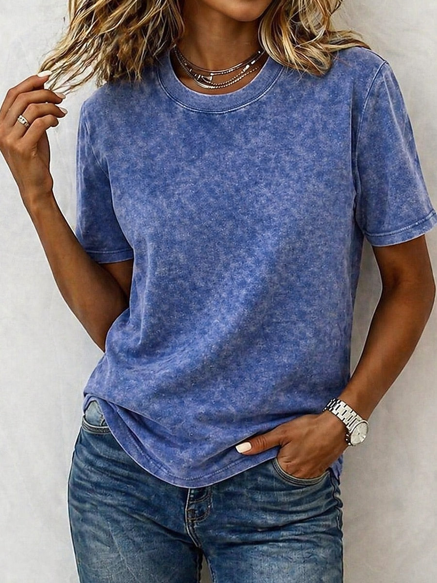 Woman wearing a blue acid wash 100% cotton crew neck t-shirt by LoomBasics and denim jeans.