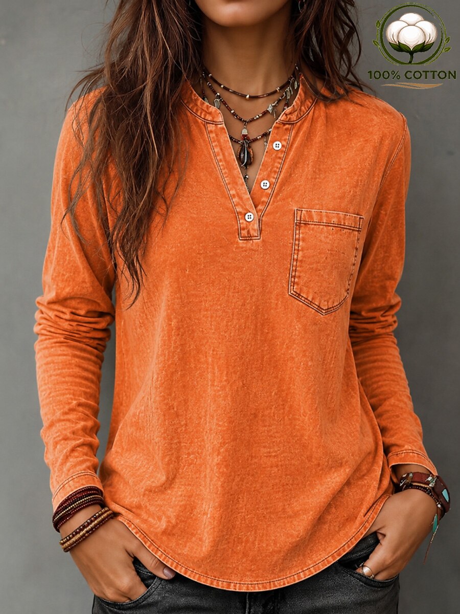 Woman wearing a LoomBasics vintage orange 100% cotton long-sleeve shirt with a pocket.