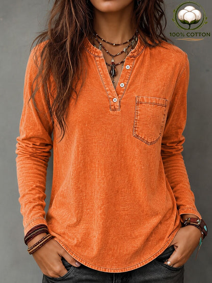 Woman wearing a LoomBasics vintage orange 100% cotton long-sleeve shirt with a pocket.