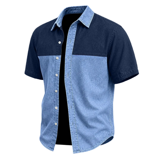 A men's short-sleeve button-up shirt with a color-blocked design, featuring a dark navy blue upper yoke and collar, and a light blue denim lower body and sleeves. The shirt is shown open against a solid white background.