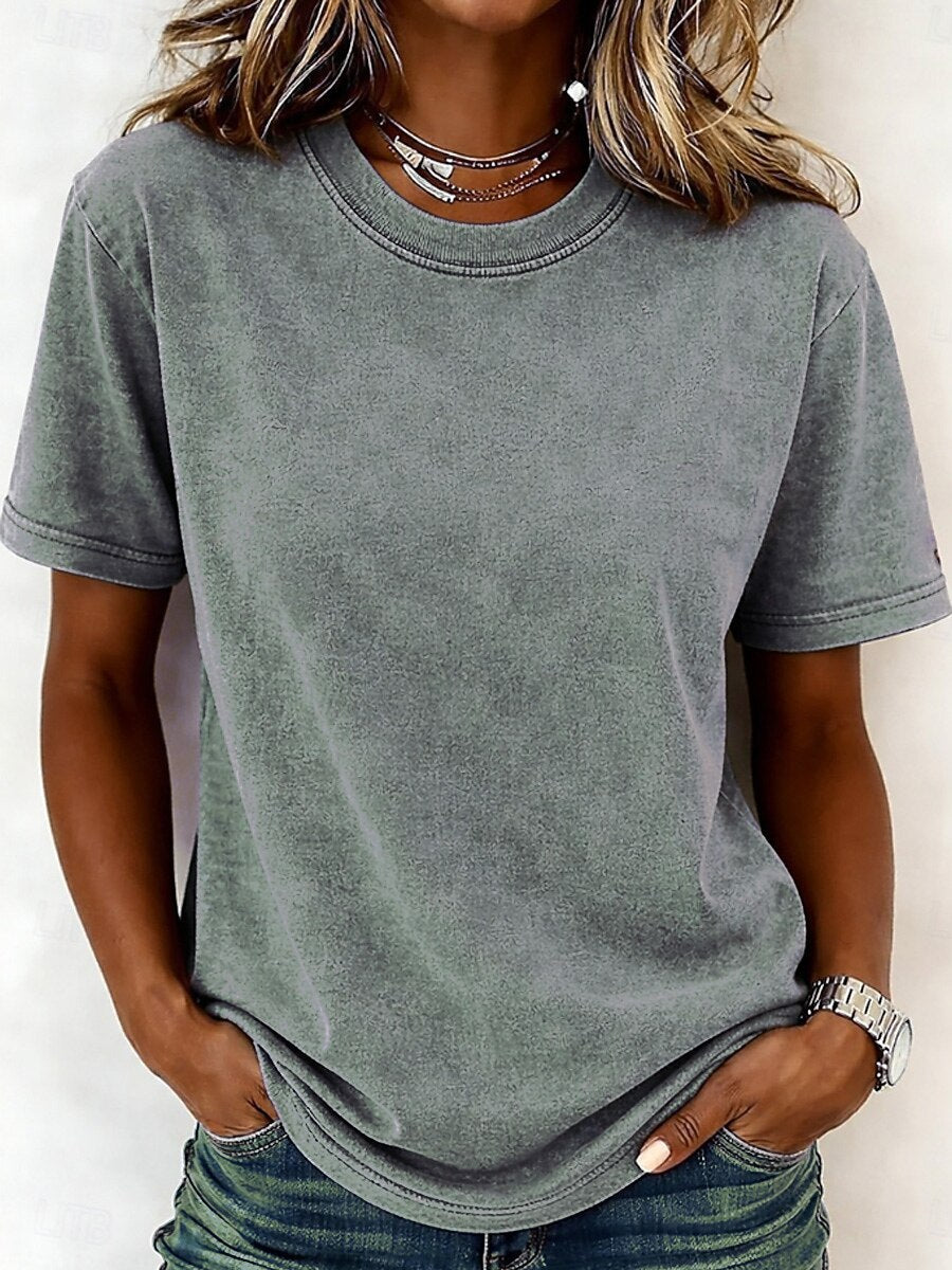 Woman wearing a LoomBasics grey 100% cotton crew neck t-shirt and blue jeans.