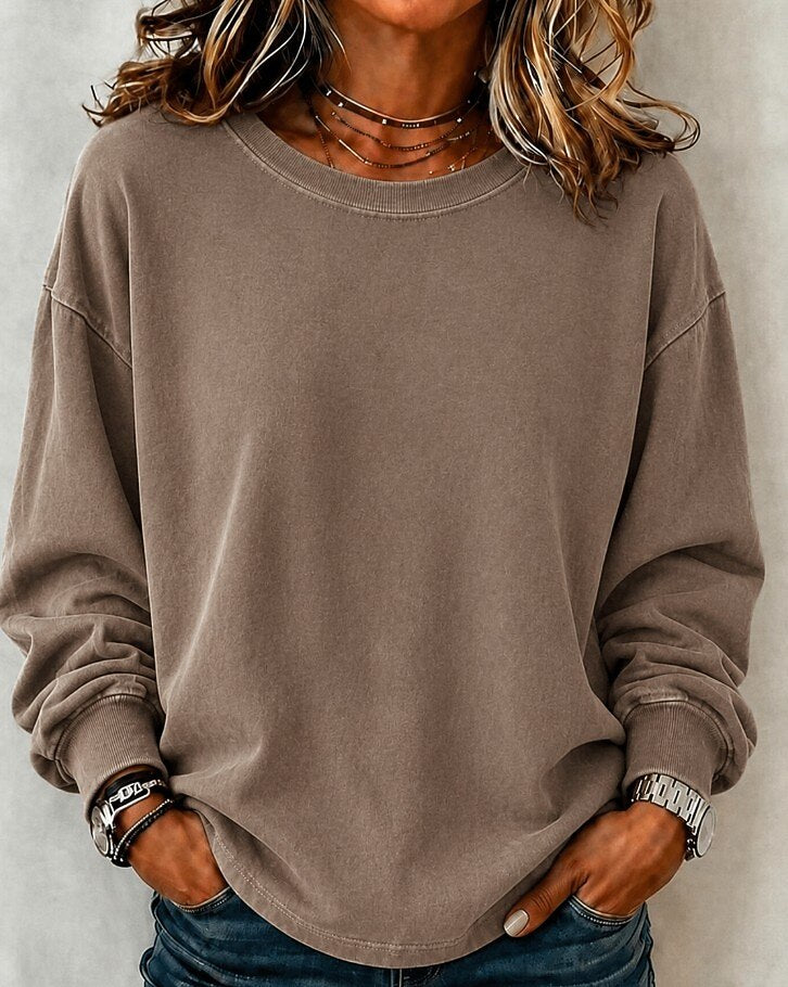 Woman wearing a LoomBasics washed 100% cotton crewneck sweatshirt in taupe brown.