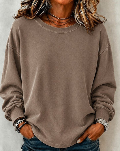 Woman wearing a LoomBasics washed 100% cotton crewneck sweatshirt in taupe brown.