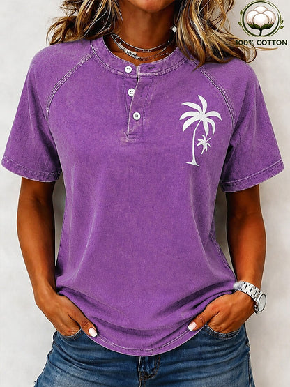 Woman wearing a purple 100% cotton washed henley tee by LoomBasics with a white palm tree design