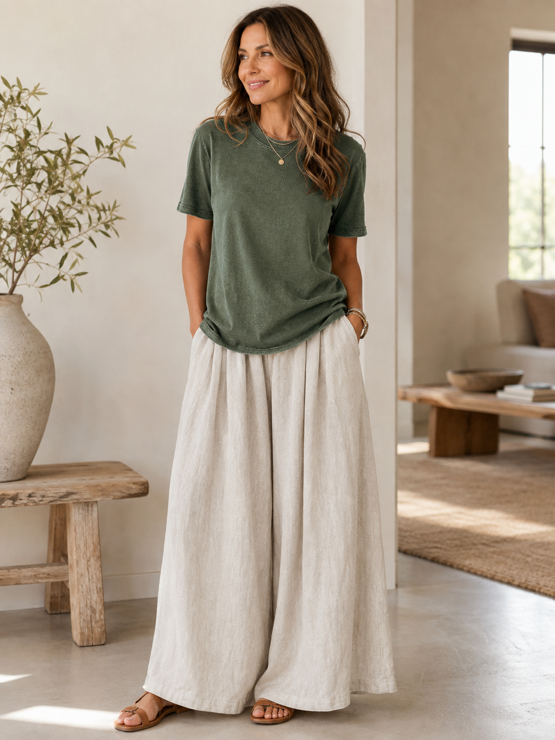 Woman wearing a LoomBasics olive green cotton crew neck t-shirt and wide-leg linen pants.