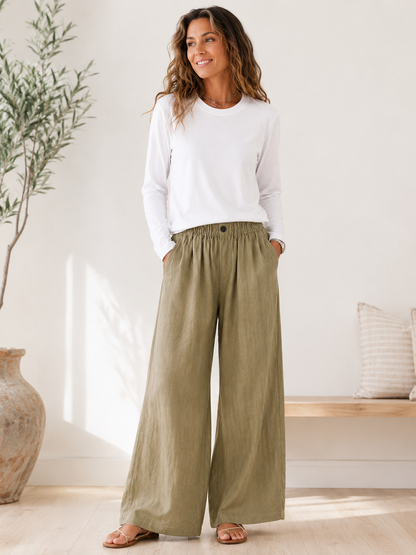 Woman wearing a LoomBasics white 100% cotton crew neck tee and olive green wide-leg trousers.
