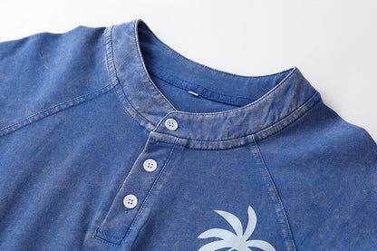 Close-up of a blue 100% cotton washed Henley tee by LoomBasics with white buttons.