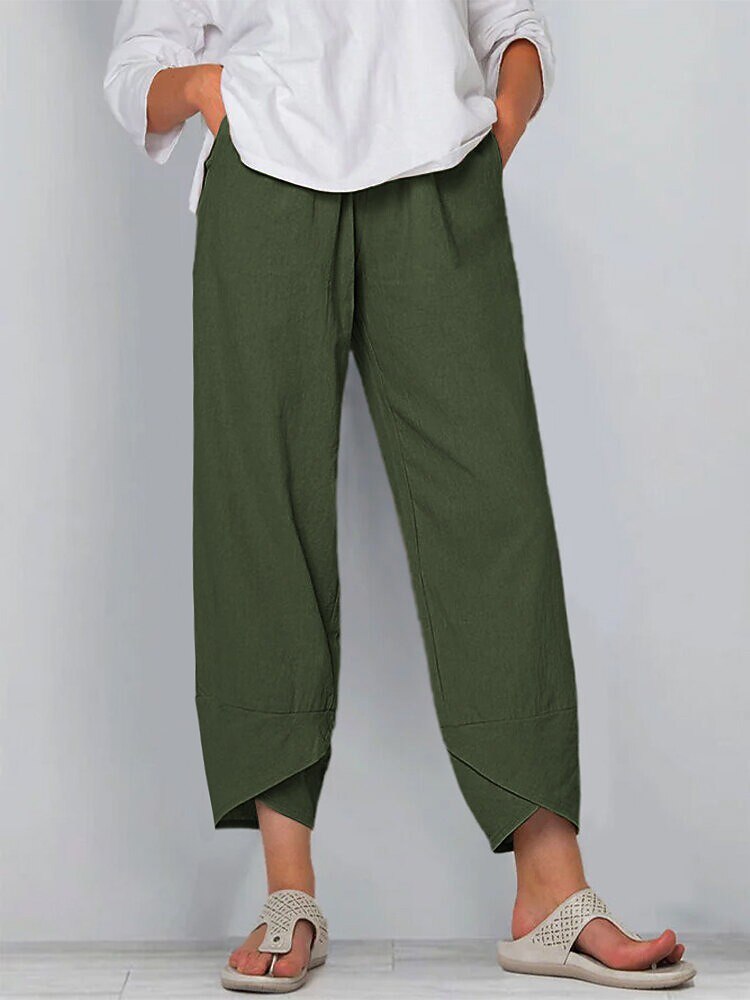 Woman wearing LoomBasics olive green 100% cotton capri pants and a white top.