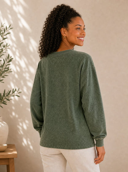 Woman wearing a LoomBasics olive green 100% cotton crewneck sweatshirt from the back.