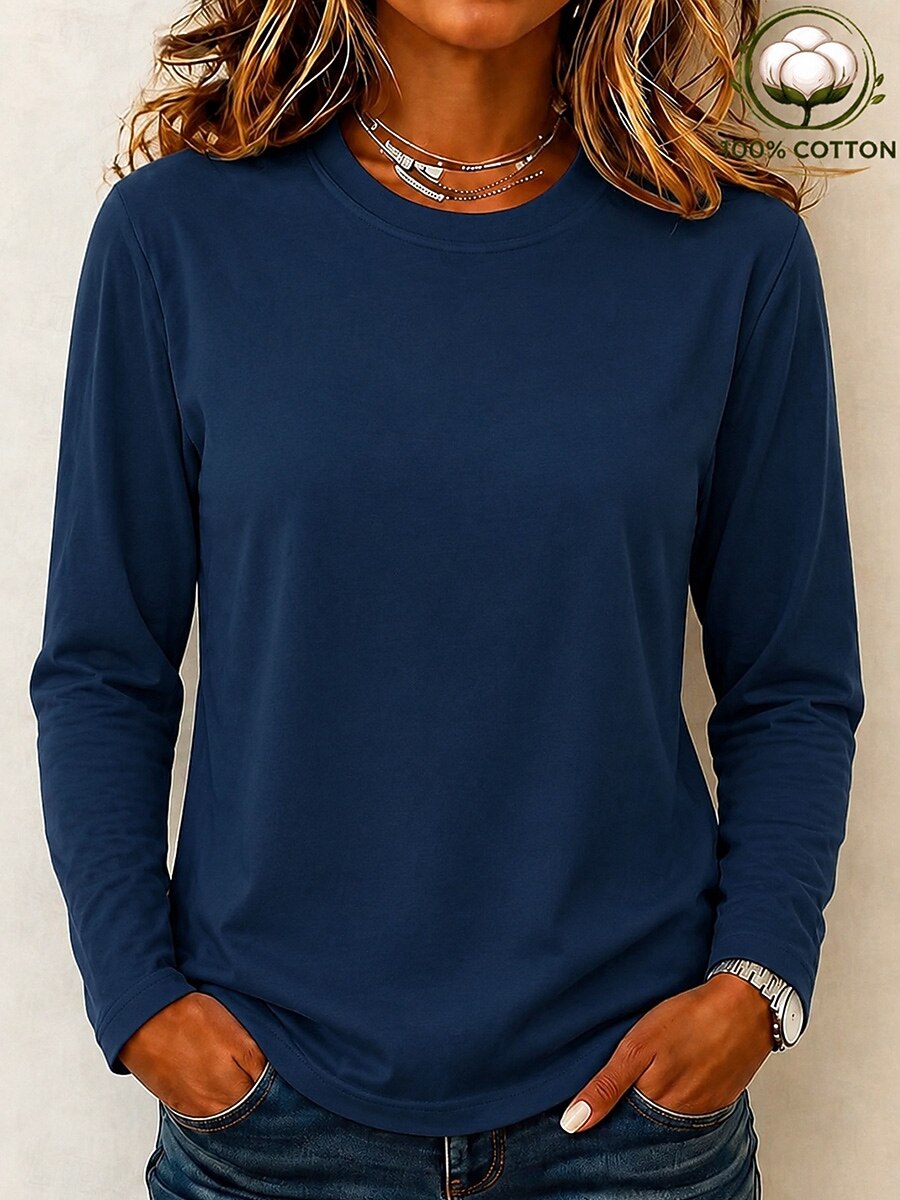 Woman wearing a LoomBasics 100% cotton navy blue long sleeve crew neck tee and blue jeans.