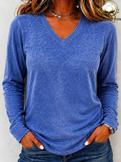 Woman wearing a LoomBasics washed 100% cotton v-neck top in blue with jeans