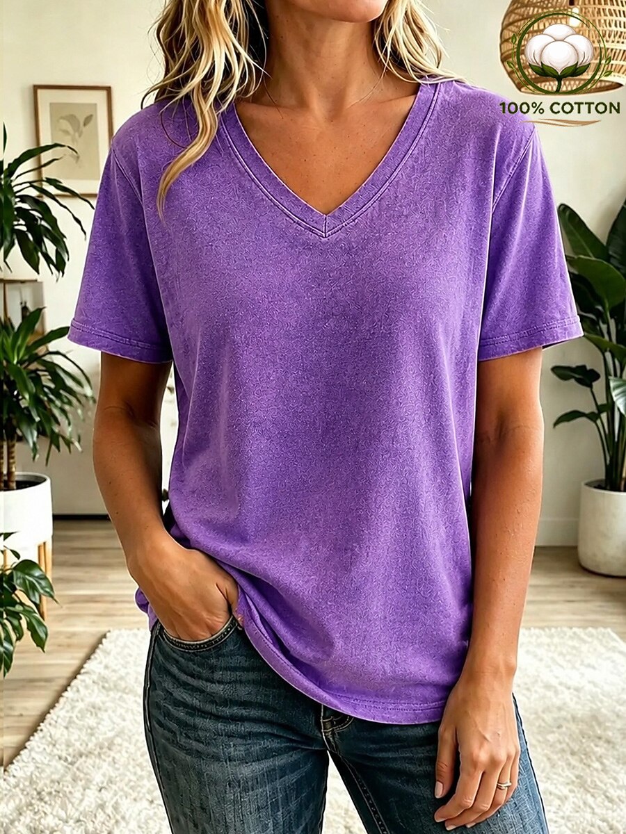 Woman wearing a LoomBasics purple 100% cotton v-neck t-shirt and blue jeans.