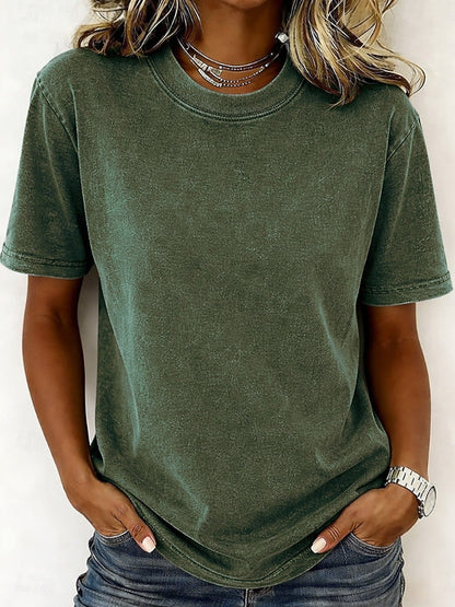 Woman wearing a LoomBasics olive green 100% cotton crew neck t-shirt and blue jeans.