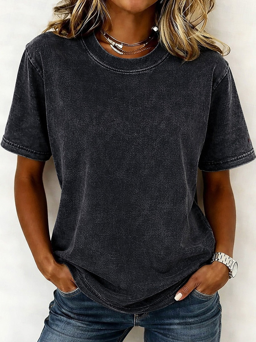 Woman wearing a charcoal gray 100% cotton crew neck tshirt and blue jeans