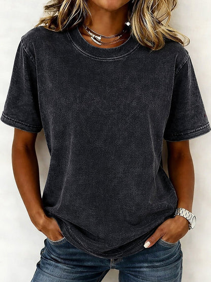 Woman wearing a charcoal gray 100% cotton crew neck tshirt and blue jeans