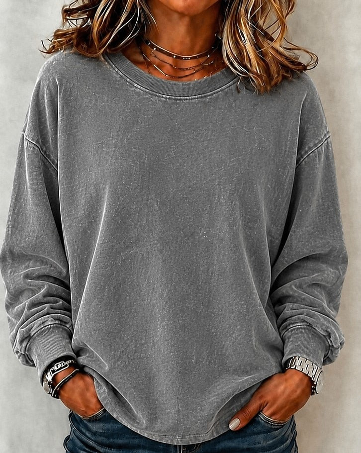 Woman wearing a LoomBasics washed grey 100% cotton crewneck sweatshirt with blue jeans