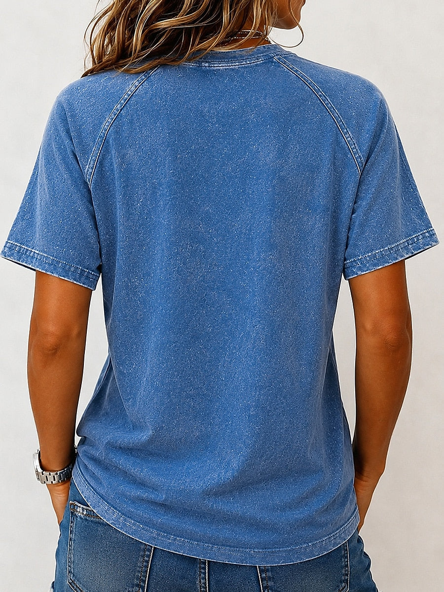 Back view of a woman wearing a LoomBasics blue 100% cotton washed Henley tee.