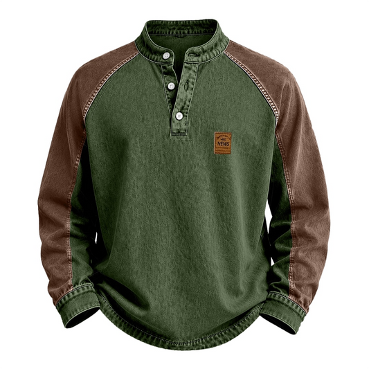 A long-sleeve raglan henley shirt with an olive green body and brown sleeves, featuring a small brown brand patch on the left chest.