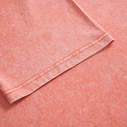 Close-up of the hem stitching on a coral pink 100% cotton crew neck t-shirt by LoomBasics