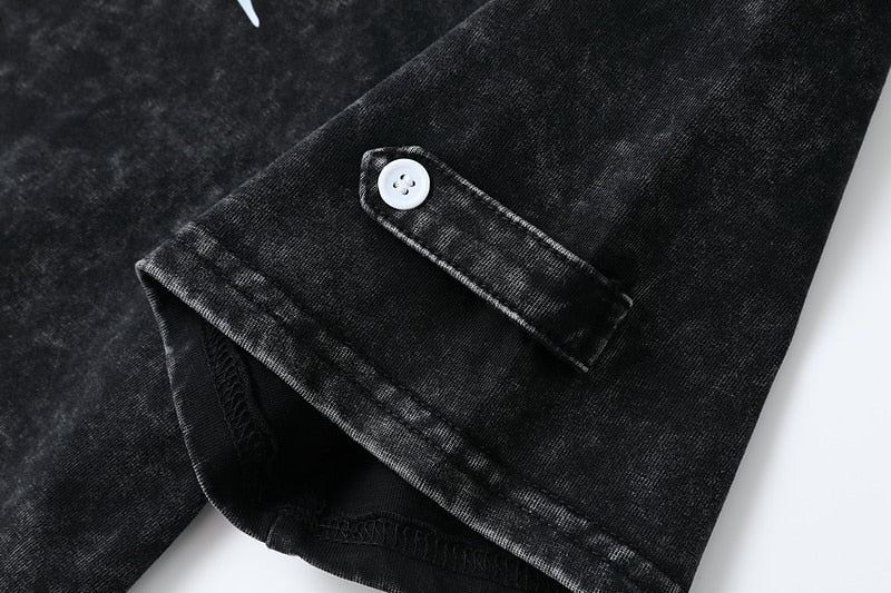 Close-up of the sleeve cuff and white button on a black 100% cotton Henley shirt by LoomBasics.