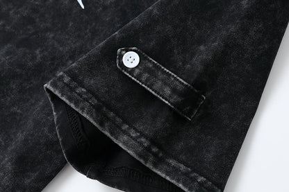 Close-up of the sleeve cuff and white button on a black 100% cotton Henley shirt by LoomBasics.