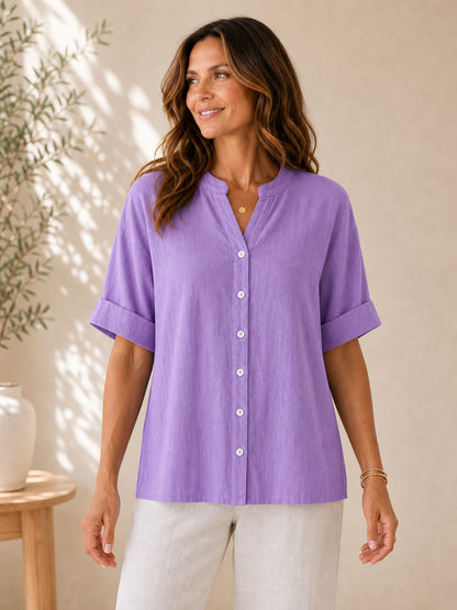 Woman wearing a LoomBasics purple V-neck 100% cotton blouse with rolled sleeves.