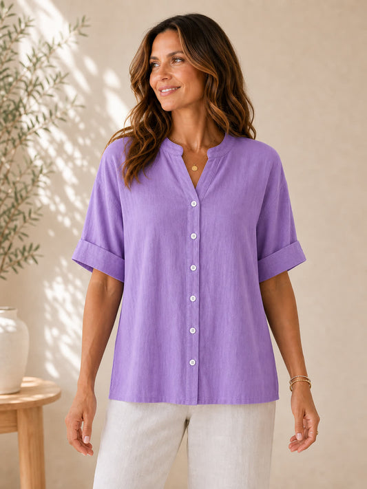 Woman wearing a LoomBasics purple V-neck 100% cotton blouse with rolled sleeves.