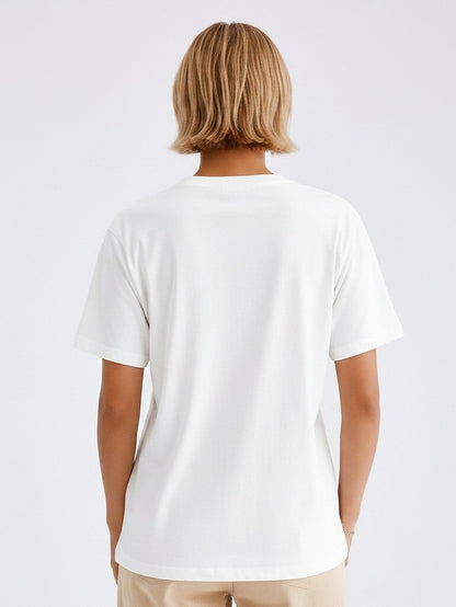 Back view of a woman wearing a white LoomBasics 100% cotton floral tee.