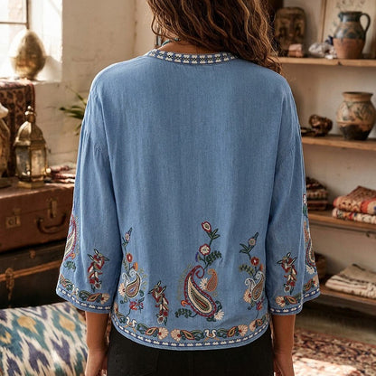 Back view of a LoomBasics blue cotton boho blouse with floral embroidery